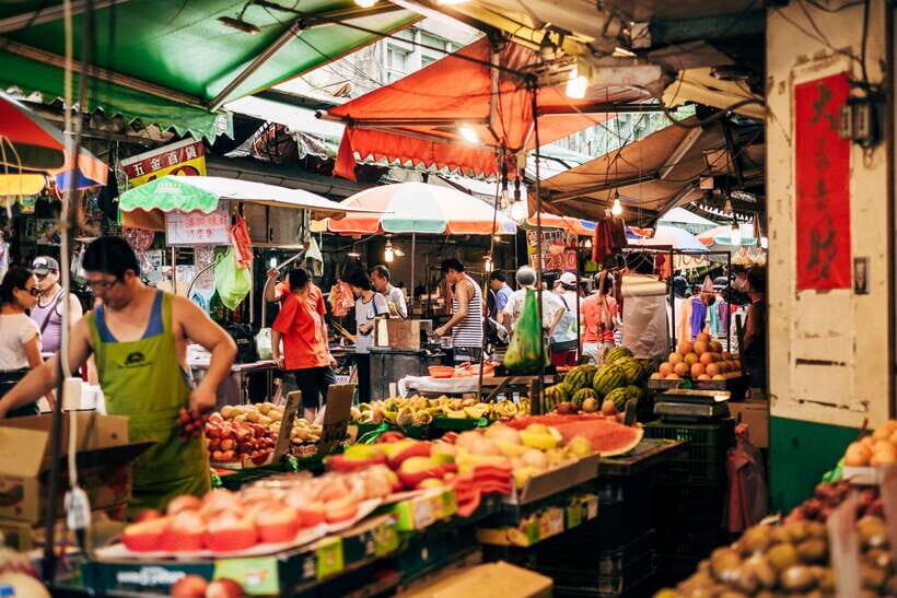 Iconic Food Tour: Local Street Food, Drinks & Sites - Entering Xinyi’s wet market where locals actually shop